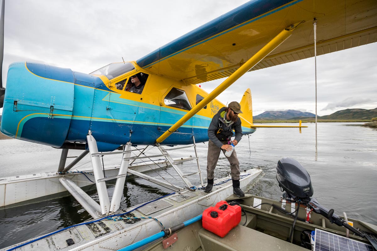 Alaska FIshing guide loading boat from plane