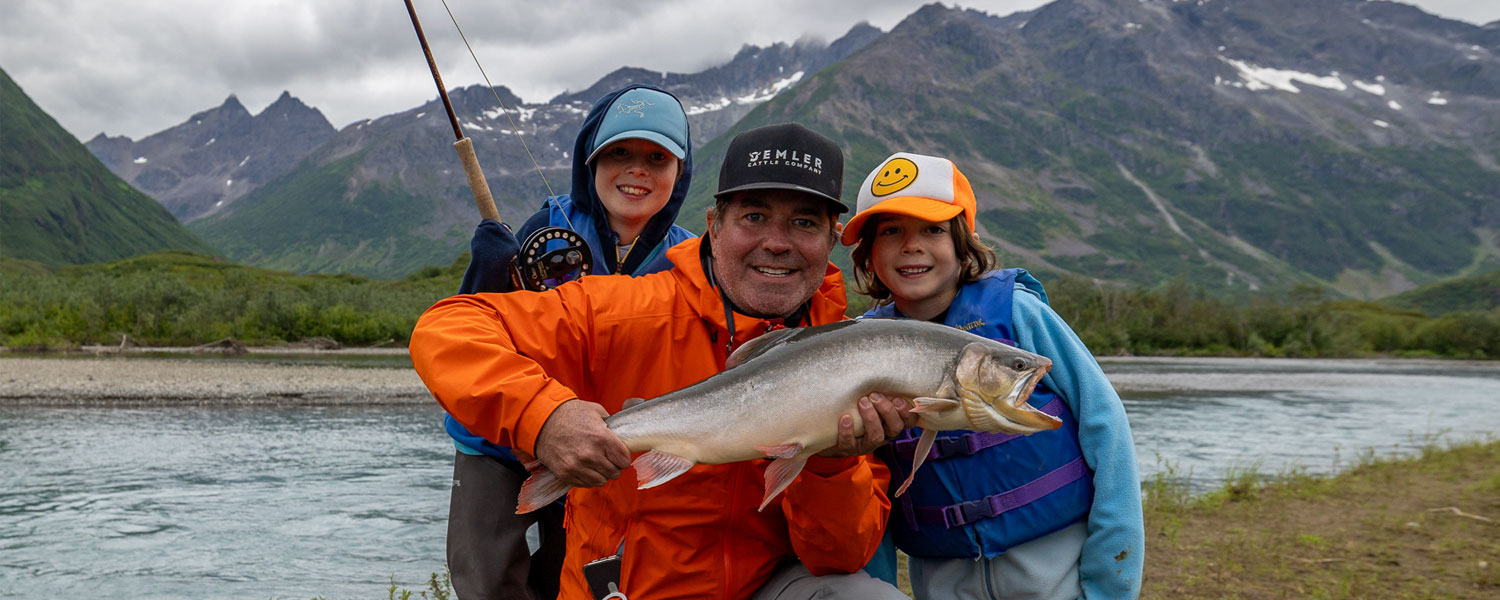 Father and two kids with Alaskan Char